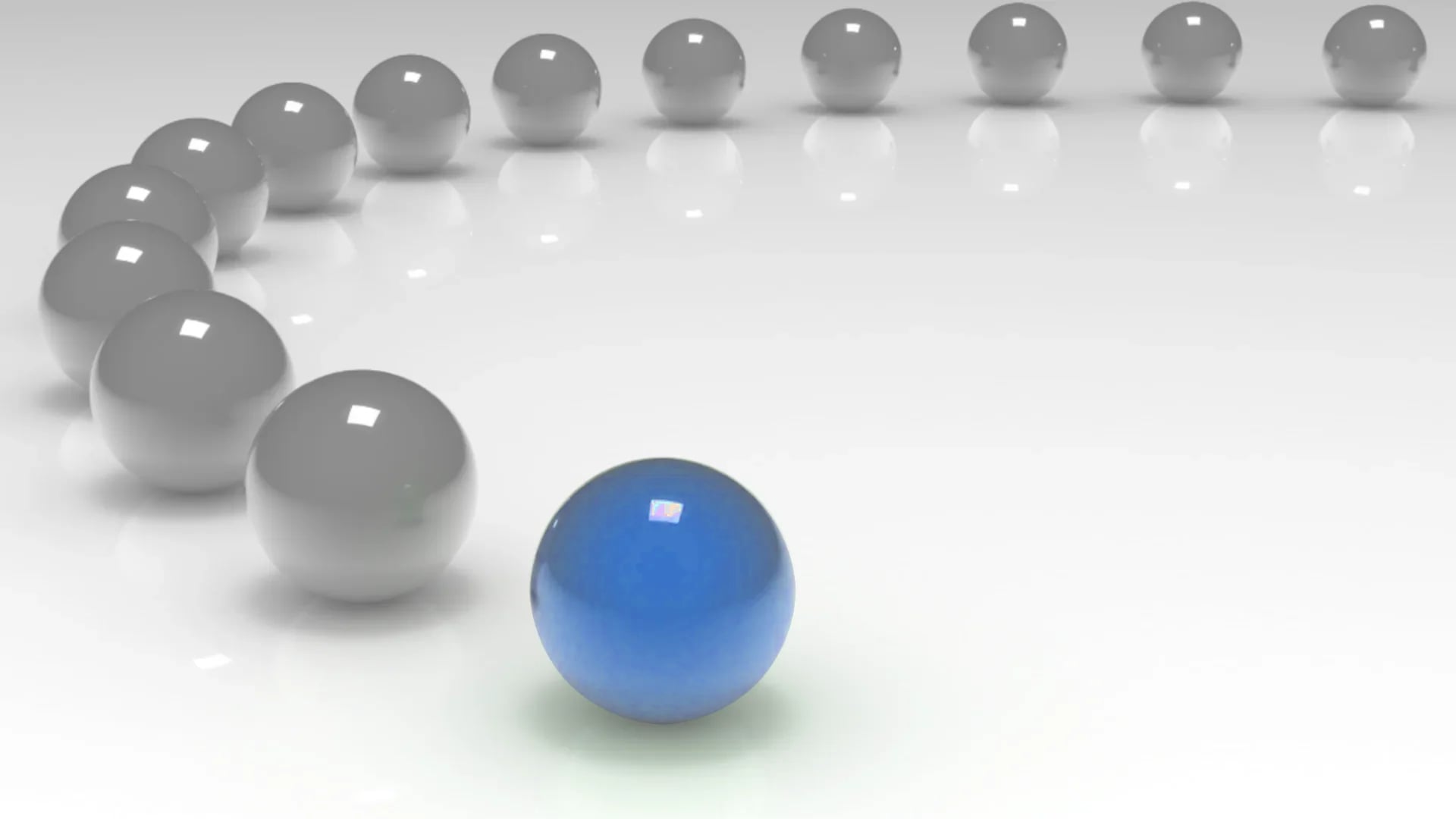 Un gruppo di sfere disposte lungo una traiettoria curvilinea in cui quella di testa ha una luminescenza blu mentre le restanti hanno una luminescenza grigia.